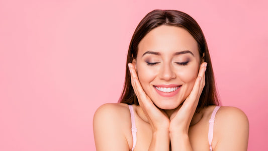young woman with her hands to her cheeks smiling