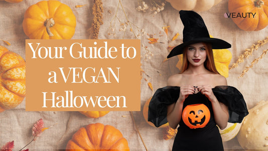 Woman disguised as a witch holding a Halloween Jack o lantern for candy. The text reads Your Guide to a Vegan Halloween.